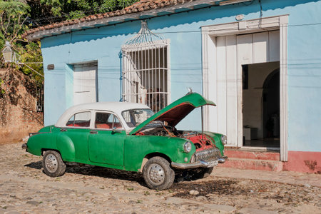 Vintage retro green car against background of house in Trinidad, Cubaのeditorial素材