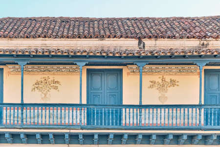 Big balcony with wooden railings of colonial Spanish style house in historic center Trinidad, Cubaの写真素材