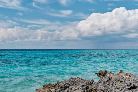 Beautiful sea and cloud landscape. Caribbean sea coast with turquoise water and stony beachの写真素材
