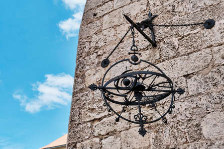 Metal astronomical sculpture hanging on old wall of Convent de San Francisco de Asis in Old Havanaの写真素材