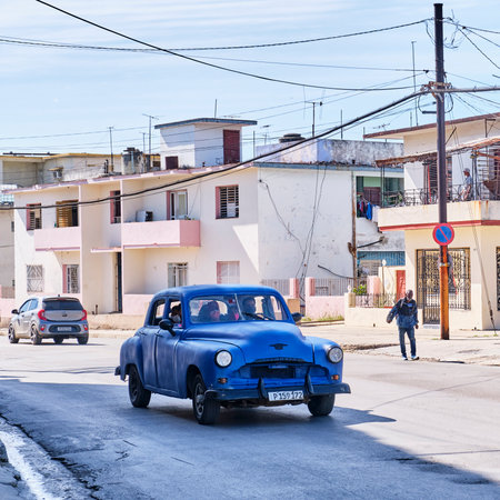 Street and buildings in non-tourist area of Havana, Cuba. Local people and red retro car.のeditorial素材