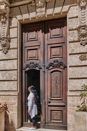 Front wooden high door in colonial building of old Havana, with beautiful ornamental carvings.のeditorial素材