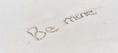 Text Be mine written on white sand of tropical beach.の写真素材