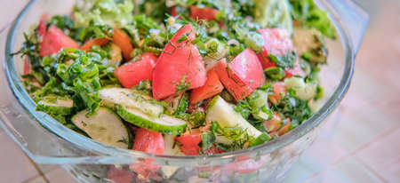 Salad of fresh vegetables and herbs, with vegetable oil. Close-up.の写真素材