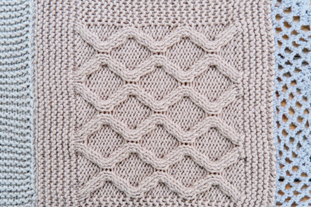 Knitted symmetry pattern of gray wool in form of close-up rhombusesの写真素材