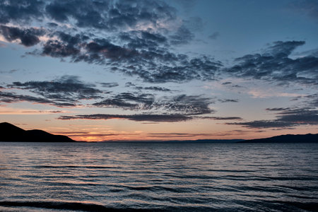 Barguzinsky Bay of Lake Baikal, Russia. Colorful sunset. Scenic clouds on sky.の写真素材