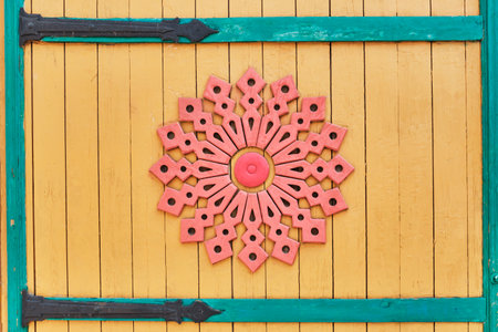 Detail of colored wooden gate with carved pattern. Round wooden decoration element. Traditional Tatar ornament. Kazan, Russia. close-upの写真素材