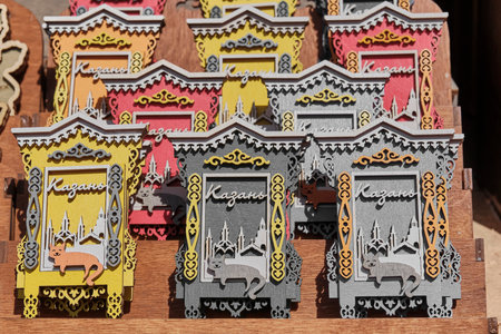 Kazan, Russia - June 8, 2023: Colorful panels made of plywood, souvenirs for tourists. Silhouettes of symbolic Kazan buildings in window, carved architraves with Tatar ornament, smiling catのeditorial素材