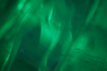 Ice illuminated by green led as abstract gradient backgroundの写真素材