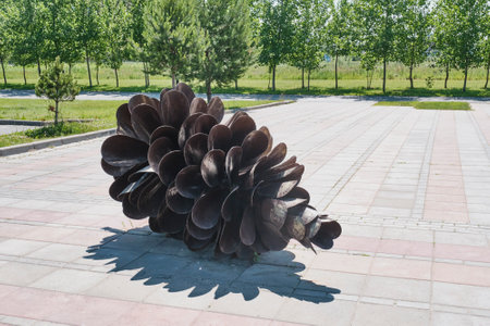 Innopolis, Russia - June 13, 2023: Symbol of wish fulfillment - large iron cones. Modern sculptures reflect concept of city - unity of nature, man and technology. Small architectural forms in park.のeditorial素材