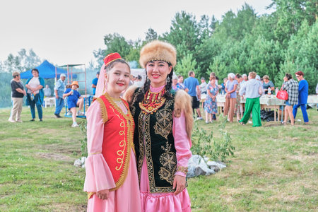 Two Asian girls in ethnic traditional clothes on village festival, Siberia, Russiaのeditorial素材