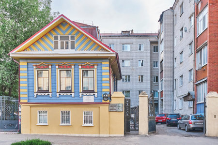 Kazan, Russia - June 15, 2023: Historic Kamal s house among modern residential buildings. Typical city wood stone mansion beginning of XX century in traditions of Tatar folk architecture.のeditorial素材