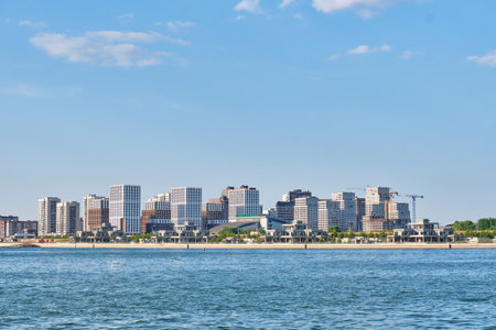 Kazan, Russia - June 16, 2023: Panorama of modern buildings of Novo-Savinsky residential area from side of Kazanka River. Facade of AK BARS Martial Arts Palace. Summer cityscapeのeditorial素材