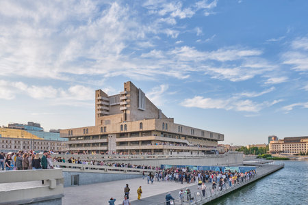 Kazan, Russia - June 17, 2023: Embankment of Lake Nizhny Kaban near Kamal Theater in downtown. People walking and listening to music at free concert. Active leisure. Summer cityscape.のeditorial素材