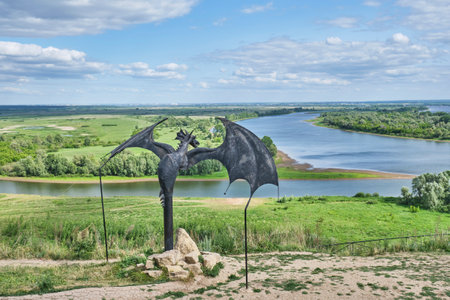 Yelabuga, Russia - June 18, 2023: Sculptural composition Dragon Oracle, Gataullin, 2016. Serpent-predictor, character of local legends. View of confluence of two rivers Kama and Toyma. Summer landscape.のeditorial素材