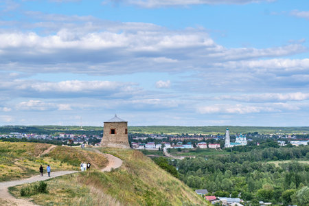 Yelabuga, Russia - June 18, 2023: Path leading to white stone tower, fortress-mosque of 12th century. Devil's hillfort, ruins of ancient settlement, archeological and historical monument. Cityscape.のeditorial素材