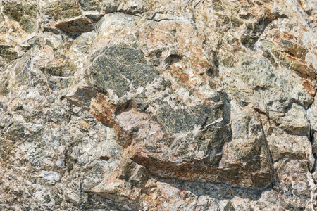 Texture of raw block of natural stone of greenish tint, similar to the coil as creative abstract background with copy space for design. Volumetric 3D effect.の写真素材