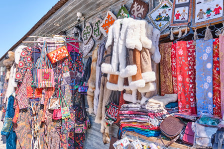 Local market with traditional national Kazakh colorful souvenirs, fur and leather products, bright...