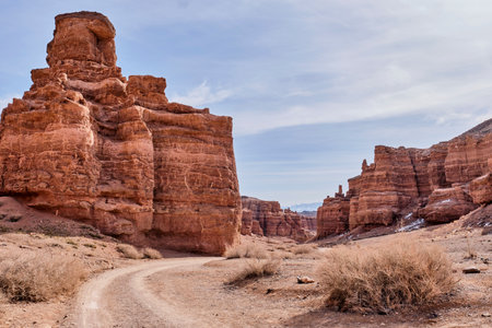 Road along amazing valley of Castles Gorge, Charyn Canyon National Nature Park in Kazakhstan. Natural monument, formed by water, wind and time, landmark near Almaty. Spring landscapeの写真素材