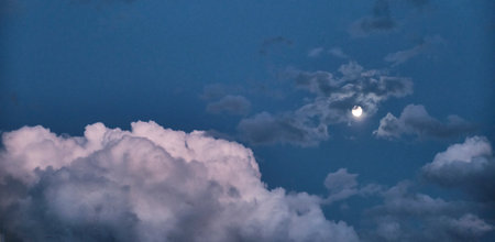 Night cloudy sky with full moon. Abstract background. Copy space. Bannerの写真素材