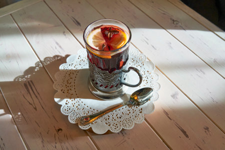 Non-alcoholic mulled wine served in vintage Soviet glass with traditional metal holder, garnished...
