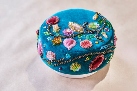 Traditional Tatar womans scullcap handcrafted with intricate bead and sequin embroidery on rich blue velvet. Features floral folk pattern with detailed embellishments. Cultural textile heritage art.の写真素材