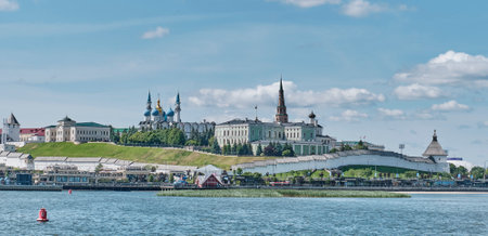 Wide-angle view of the Kazan Kremlin, a historic fortified complex in Kazan, Russia, Orthodox churches with blue domes, palace, and towers. Captured from across the Kazanka Riverの写真素材