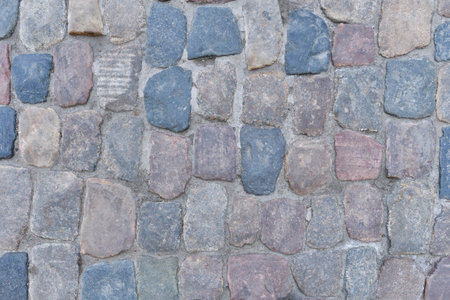 Close-up of aged 19th century cobblestone pavement with natural stone texture, suitable as historical background.の写真素材