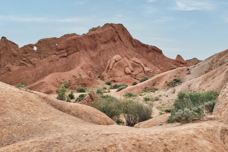 Red sandstone and clay formations in Skazka Canyon, Fairytale Canyon, near the southern shore of...