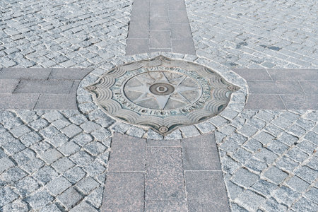 Volgograd, Russia - October 6, 2025: Close-up view of Zero Kilometer Marker for Volgograd region, set into geometric pattern of gray granite cobblestone paving tiles in city center.のeditorial素材