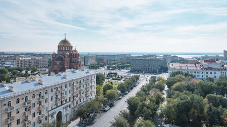 Volgograd, Russia - October 6, 2025: Panoramic view of golden domed Alexander Nevsky Cathedral and Volodarsky Street in central district, historical buildings, green park areas, and wide cityscape.のeditorial素材