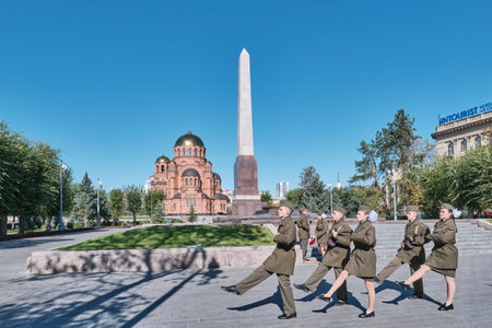 Volgograd, Russia - September 30, 2025: Youth cadets perform solemn changing of guard at Post No. 1 memorial on Heroes Alley , with Alexander Nevsky Cathedral and obelisk in background.のeditorial素材