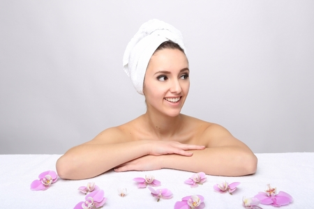 Beautiful Happy Spa Girl Isolated on a White Background.Touching  her Face. Happy Woman after Bath with Clean Perfect Skinの写真素材