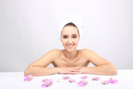 Beautiful Happy Spa Girl Isolated on a White Background.Touching  her Face. Happy Woman after Bath with Clean Perfect Skinの写真素材