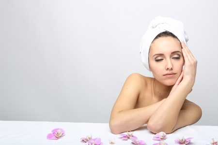 Beautiful Happy Spa Girl Isolated on a White Background.Touching  her Face. Happy Woman after Bath with Clean Perfect Skinの写真素材