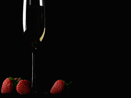 A Glass of champagne with strawberry on colorful backgroundの写真素材