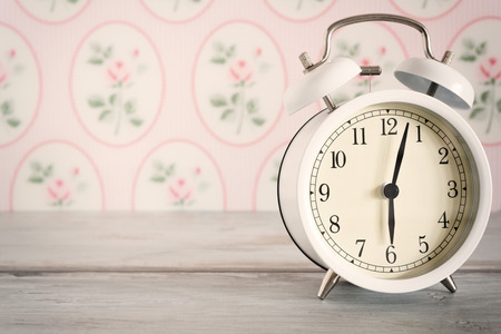 Retro alarm clock on table front wallpaper backgroundの写真素材