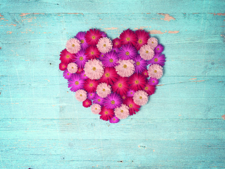 vintage heart from flowers   on wooden table, vintage valentin day backgroundの写真素材