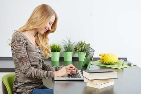 Young woman using tablet computer in an apartmentの写真素材