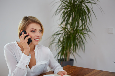 Portrait of happy young Woman Talking On Mobile Phoneの写真素材