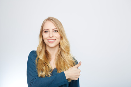 Young Woman Showing Thumb Up Sign On White Backgroundの写真素材