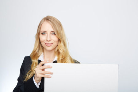 a pretty blonde girl with a blank presentation boardの写真素材