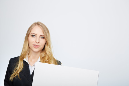 a pretty blonde girl with a blank presentation boardの写真素材