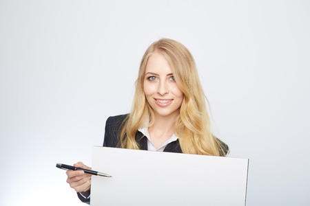 a pretty blonde girl with a blank presentation boardの写真素材