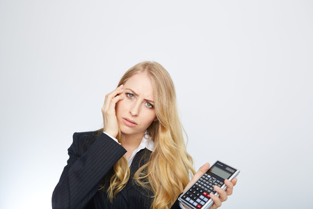 attractive smiling business woman with calculator isolated on whiteの写真素材