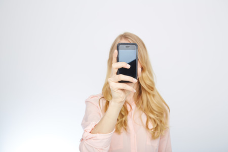 a young woman with a smart phone. isolated on white.の写真素材