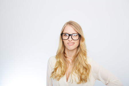 a young woman with nerd glasses. isolated on white.の写真素材