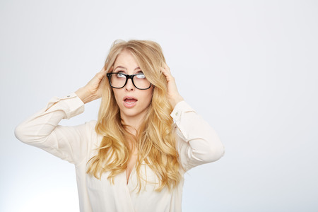 a young woman with nerd glasses. isolated on white.の写真素材