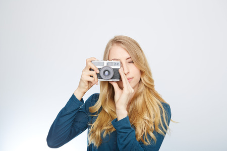 young woman taking picture with analog 35mm camera