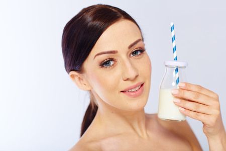 young woman with a glass of milk. in sudioの写真素材
